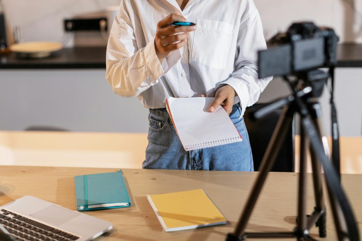 Content creator reviewing notes and camera setup to plan LinkedIn post categories and content types